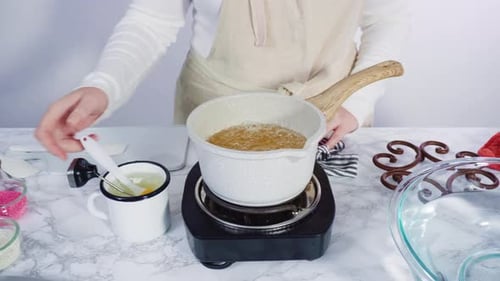 Step by step. Caramelizing sugar in a small cooking pot over the small electric stove.