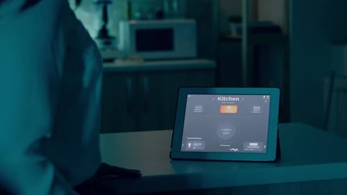 Woman uses Tablet to control Kitchen Lights