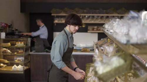 Father and Son Working in Family Bakery Store