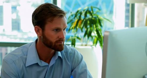 Young Man Working at Computer in Modern Office