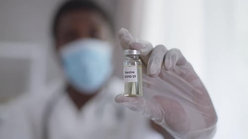 Closeup Covid19 Vaccine Jab with Male Hand Showing Syringe with Liquid Preventive Drug