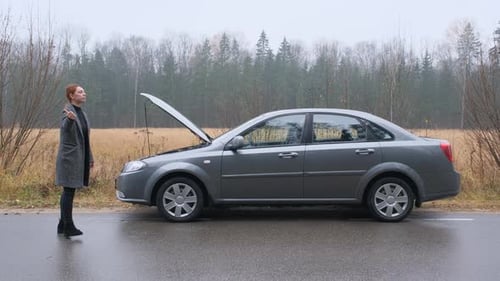 Young Woman Driver Catching Help for Her Broken Car, Accident at Empty Country Road