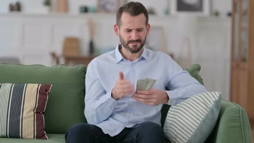 Man Counting Money, Worried About Finances Indoors
