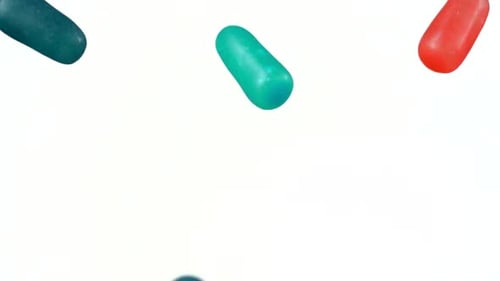 Colorful Candies Falling Against White Background