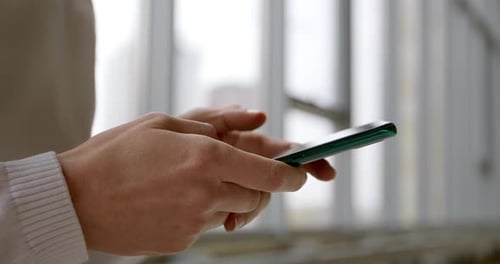 Close-up of a mobile phone in hands. Using a smartphone to chat online.