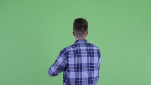 Rear View of Young Hipster Man Touching Something