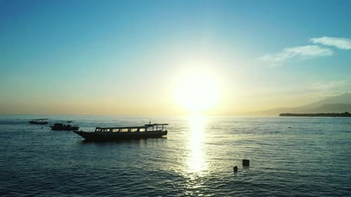 Wide angle above island view of a paradise sunny white sand beach and blue sea background in high re