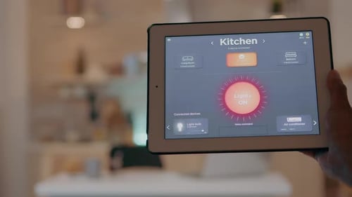 Man Controls Smart Home with Tablet in Kitchen