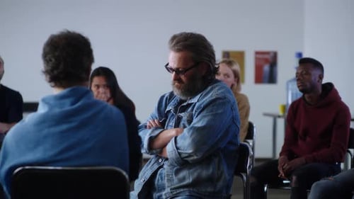 Adults Sitting in a Circle Listening