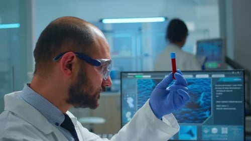 Scientist Examines Test Tube in Laboratory