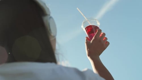 Looking at Sky Through Soda Cup
