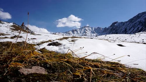 Time laps of clouds on a blue sky in a mountainous area, Snow-capped mountains, they float shadows