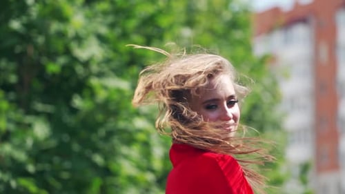 Portrait of beautiful woman. Happy woman in dress walking outdoors