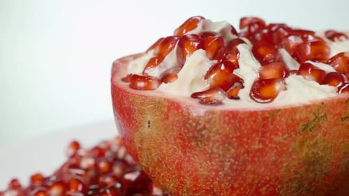 Pomegranate Half Showing Seeds Zooming Around Fruit