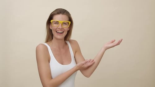 Woman in Yellow Glasses Smiling and Gesturing
