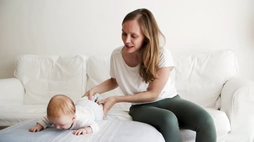 Mother Plays with Smiling Infant in Bright Living Room