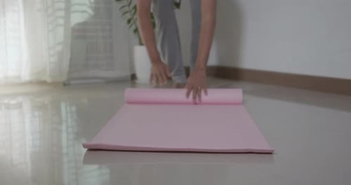 Adult Rolling Up Pink Yoga Mat Indoors