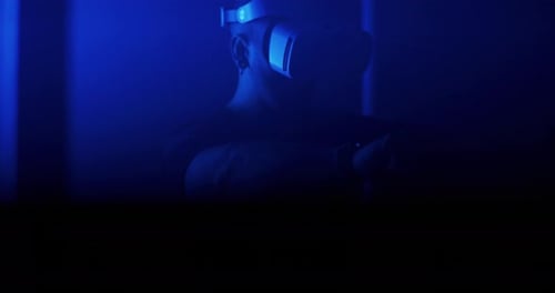 Male Interacting with Virtual Reality Near Flickering Lamps