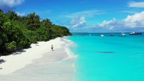 Beautiful beauty model relaxing in the sun at the beach on paradise white sand and blue 4K backgroun