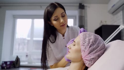 Woman Receiving Facial Treatment in Medical Office