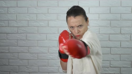 Woman in Boxing Gloves Throwing Punches