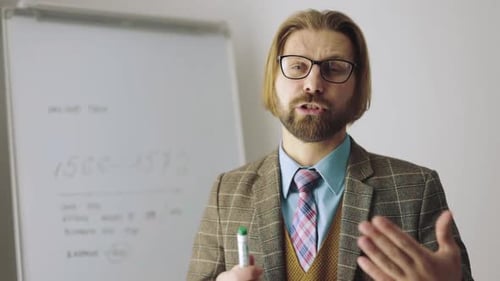 Man Giving Presentation in Workplace Holding Marker