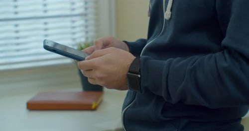 Man Hands Using a Smart Phone, Close Up. Young Man Holding Mobile Smart Phone. Guy Using Mobile