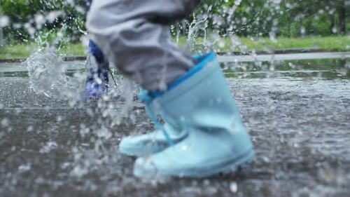 Children Jumping in Puddle