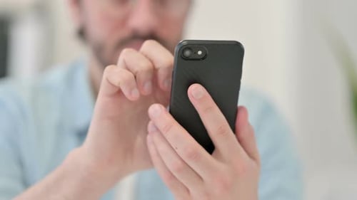 Close Up of Young Man Using Smartphone