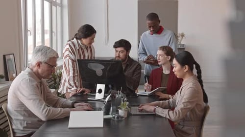 Colleagues Work Together in an Open Office