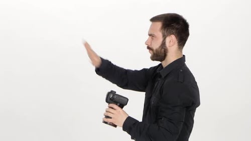 Young Man Taking Photos in Bright Studio