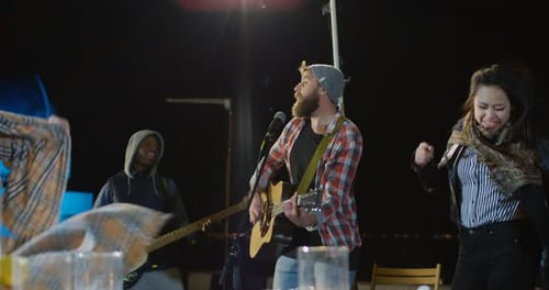 Live Music Performance at Outdoor Nighttime Gathering