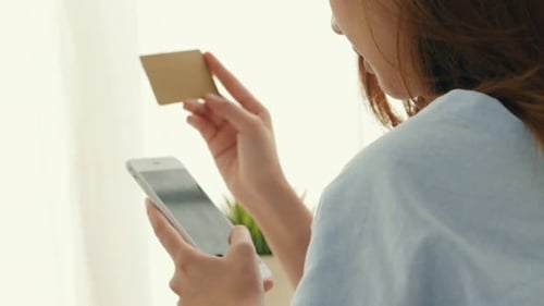 Woman Shopping Online Using Phone and Card