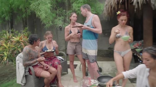 Friends Enjoying a Meal Together in Tropical Setting