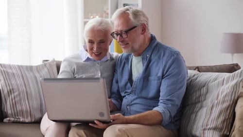 Senior Couple Video Calling on Laptop at Home