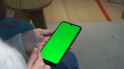 Woman Scrolling on Cell Phone with Green Screen