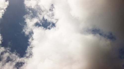 Clouds Moving Through Blue Sky in Daytime