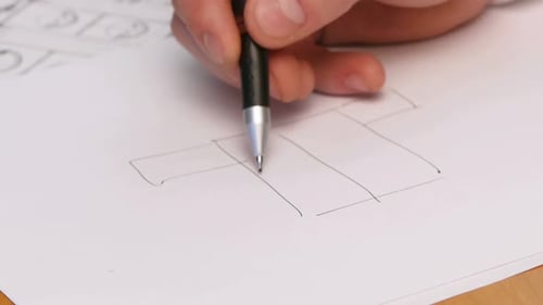 Person's Hand Drawing Plan On Blue Print. Close-up