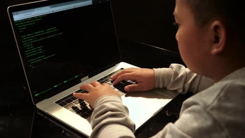 Young Boy Writing Code On Laptop