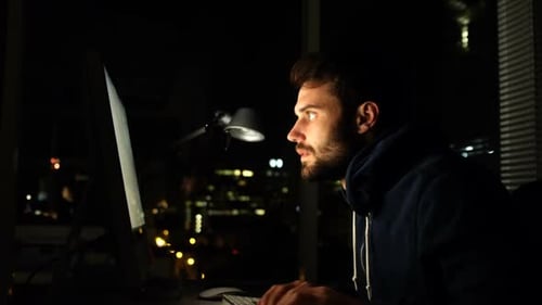 Hacker using computer at night