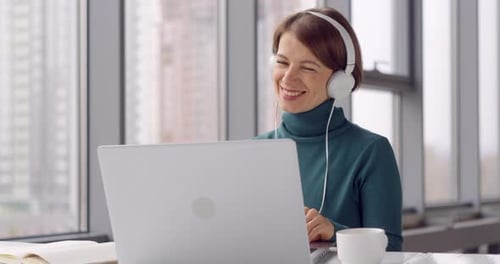 Woman Works on Laptop in Bright Office