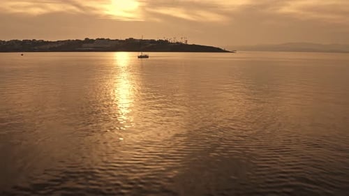 Sailboat on Ocean at Sunset Aerial