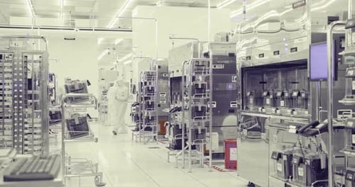 Workers in clean suits in a Semiconductor manufacturing facility