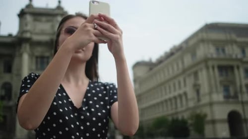 Female Traveler is Taking Photo of Landmarks in Hungary By Smartphone