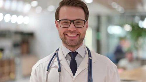 Doctor in Glasses Smiling in Medical Setting