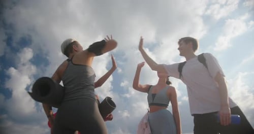 Friends Cheering with High Five After Exercise