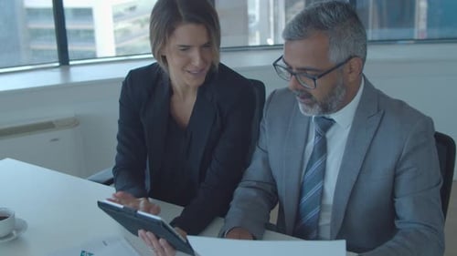 Professionals Reviewing Data in Office Setting