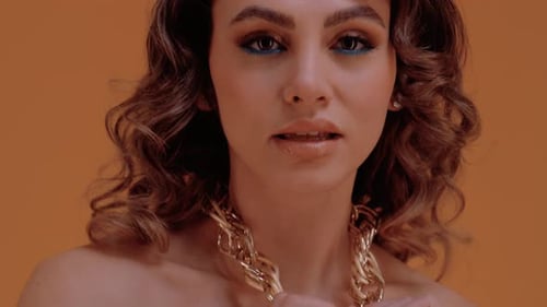 Woman Posing with Gold Chain Necklace, Close Up