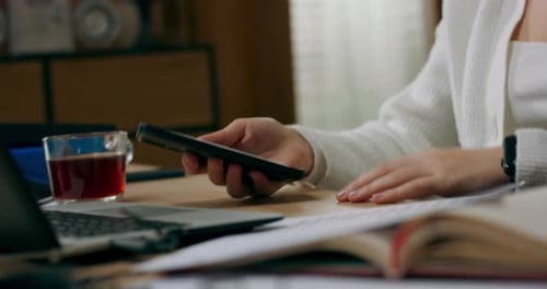 Woman Using Smartphone, Relaxing with Music Indoors