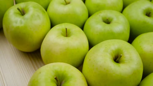 Fresh Green Apples Arranged on Wooden Surface